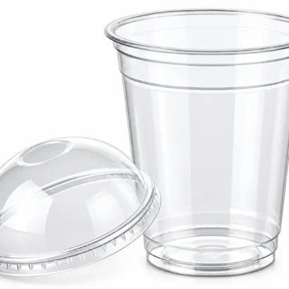 Transparent plastic frappé cups with dome lids on a dark surface