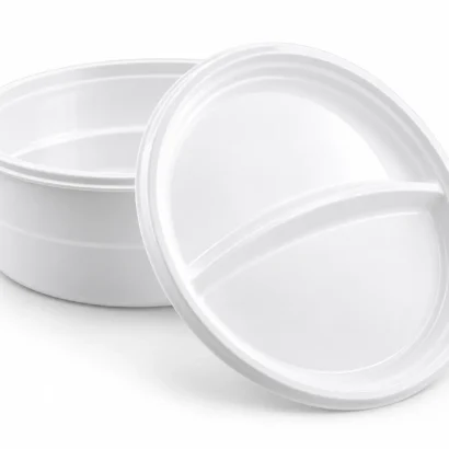 White plastic compartment dinner plates on a light background