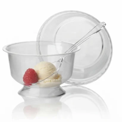 Individual stemmed plastic dessert cup with ice cream, raspberry and spoon