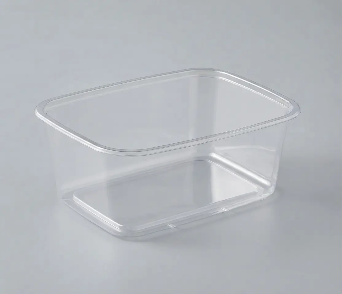 Transparent rectangular butcher's tray on a dark surface